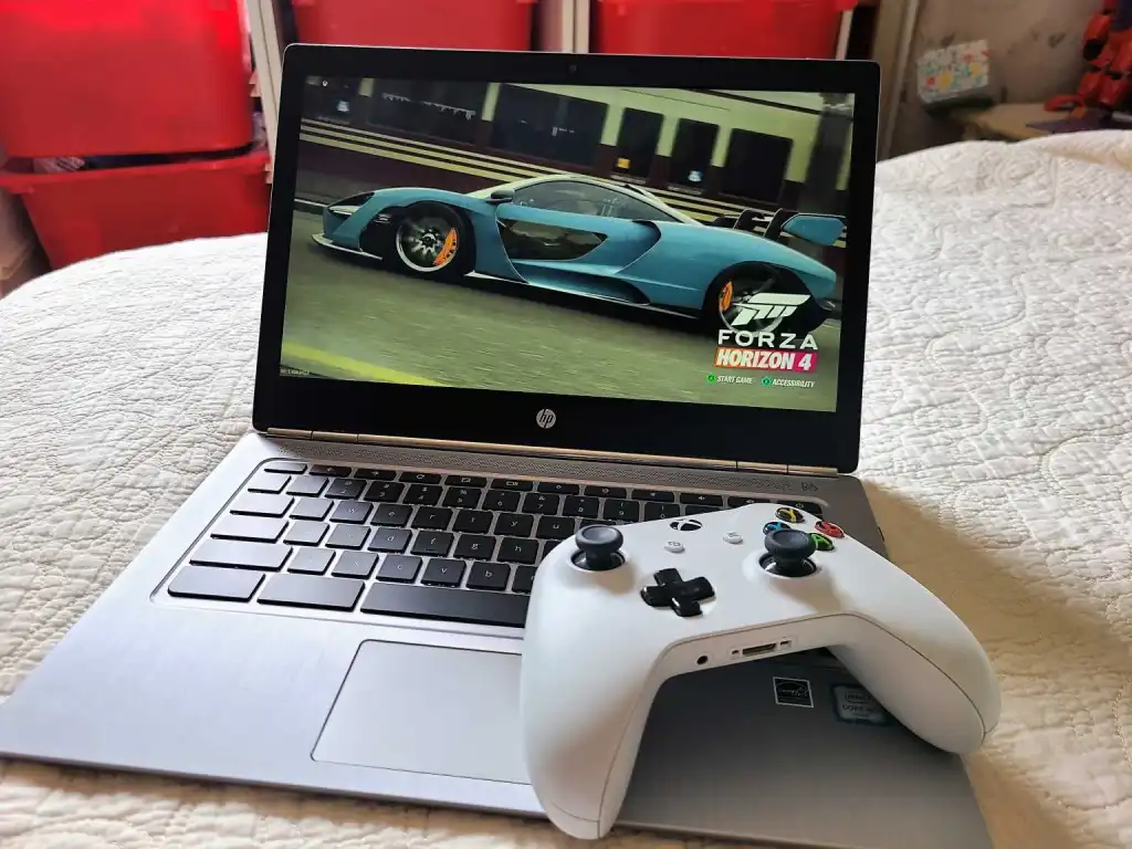 Photo of an Xbox controller laying on a Chromebook laptop running Forza Horizon 4